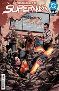 Comic book cover featuring a superhero lying on rocks with 'Absolute Superman' and 'Welcome to Smallville' text.