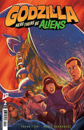 Comic book cover featuring 'Godzilla Here There Be Aliens' with a spaceship and people in front of a mountain.